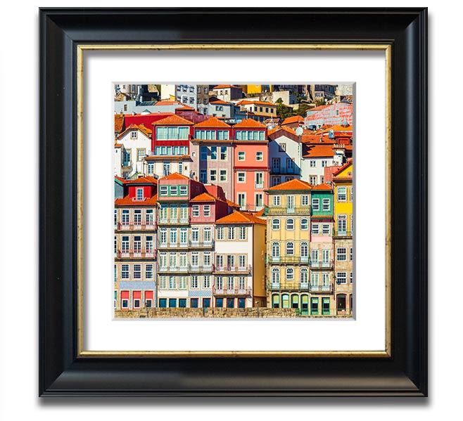 A beautifully framed print of coastal apartments, showcasing vibrant colors and intricate details, ready to hang on the wall.