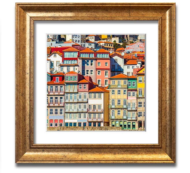 A beautifully framed print of coastal apartments, showcasing vibrant colors and intricate details, ready to hang on the wall.