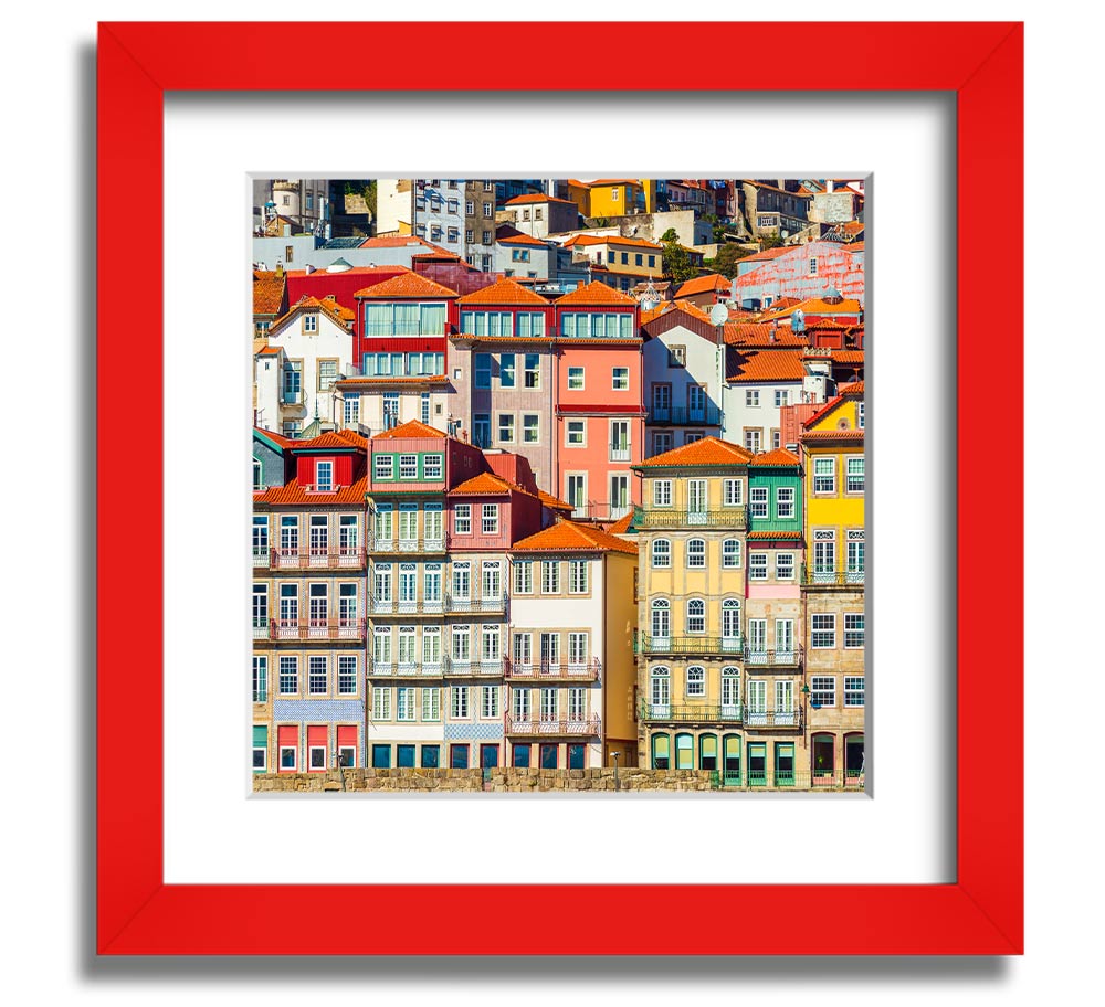 A beautifully framed print of coastal apartments, showcasing vibrant colors and intricate details, ready to hang on the wall.