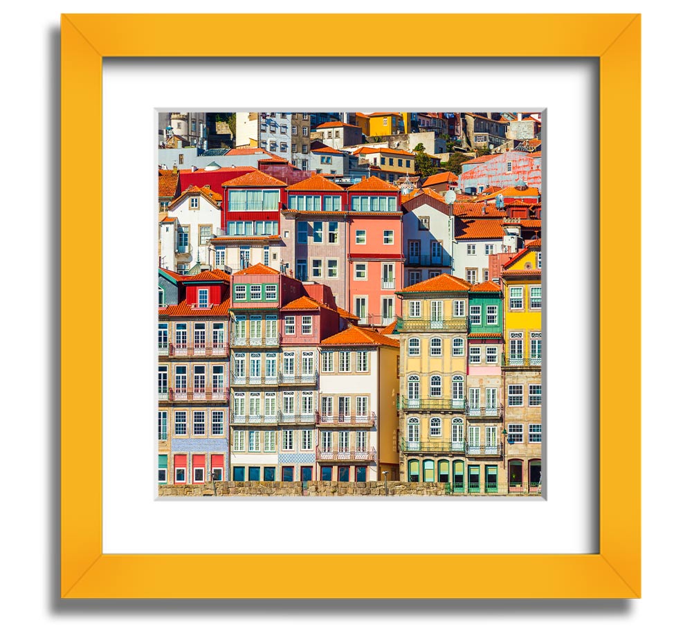 A beautifully framed print of coastal apartments, showcasing vibrant colors and intricate details, ready to hang on the wall.