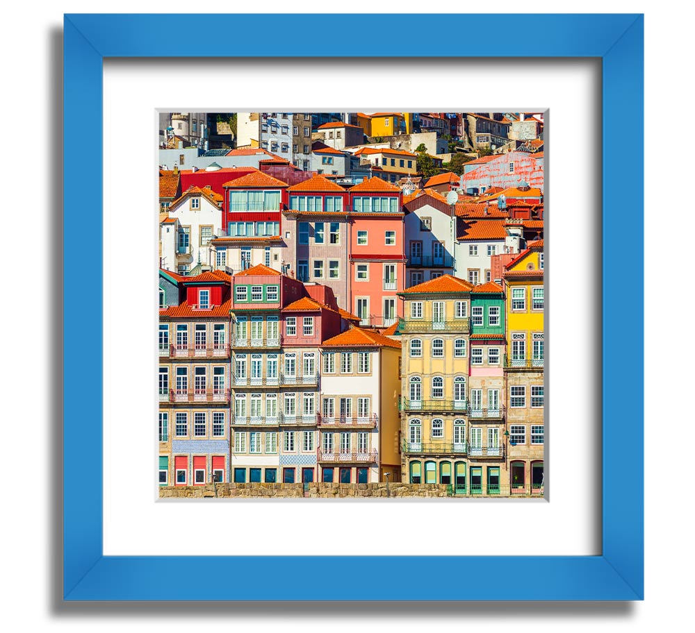 A beautifully framed print of coastal apartments, showcasing vibrant colors and intricate details, ready to hang on the wall.