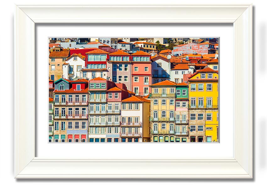 A beautifully framed print of coastal apartments, showcasing vibrant colors and intricate details, ready to hang on the wall.