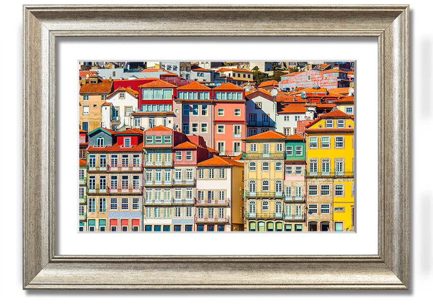 A beautifully framed print of coastal apartments, showcasing vibrant colors and intricate details, ready to hang on the wall.