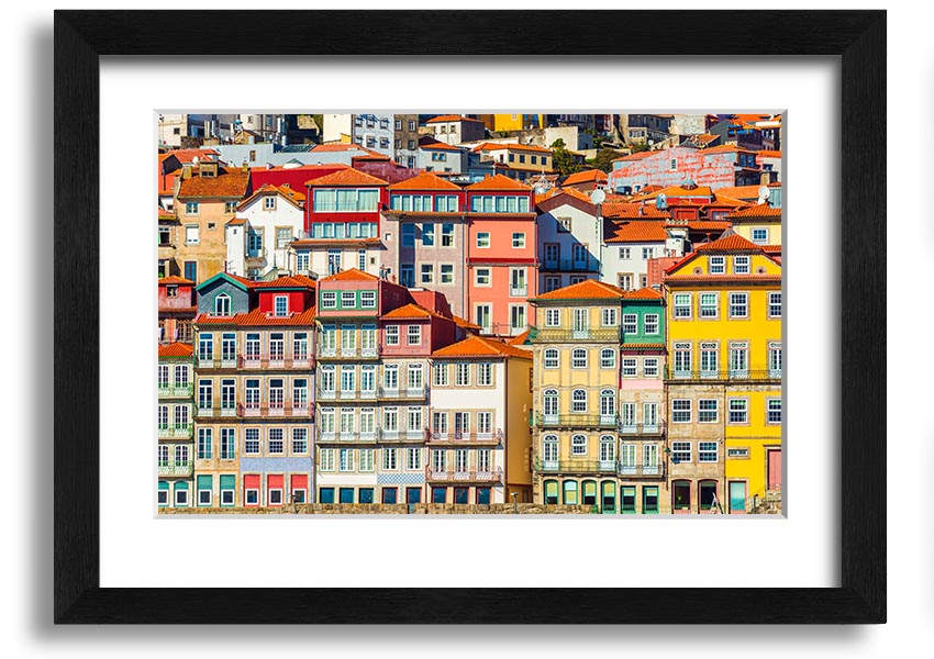 A beautifully framed print of coastal apartments, showcasing vibrant colors and intricate details, ready to hang on the wall.