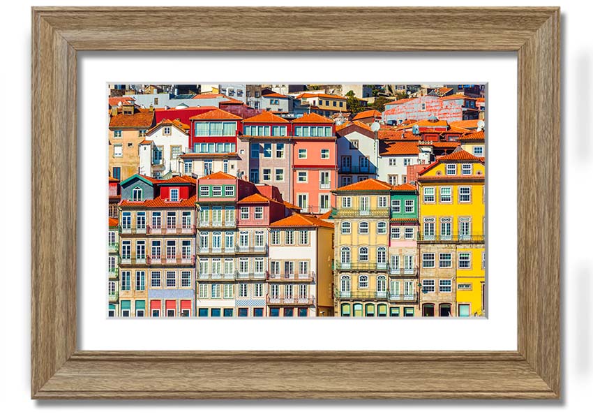 A beautifully framed print of coastal apartments, showcasing vibrant colors and intricate details, ready to hang on the wall.