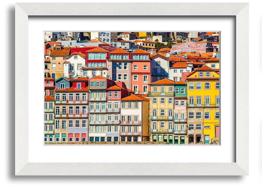 A beautifully framed print of coastal apartments, showcasing vibrant colors and intricate details, ready to hang on the wall.