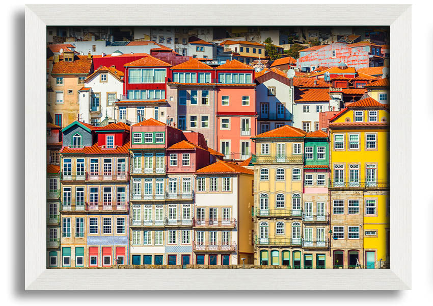 A beautifully framed print of coastal apartments, showcasing vibrant colors and intricate details, ready to hang on the wall.