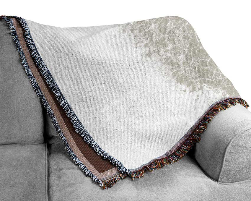 A luxurious Apple Blossom Tree throw blanket made from 100% cotton, featuring a thermal weave design, draped elegantly over a couch.