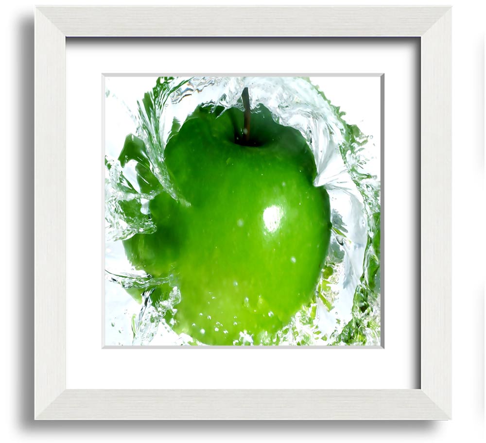 A vibrant square framed print of apples splashing in water, showcasing bright colors and dynamic imagery, ready to hang.