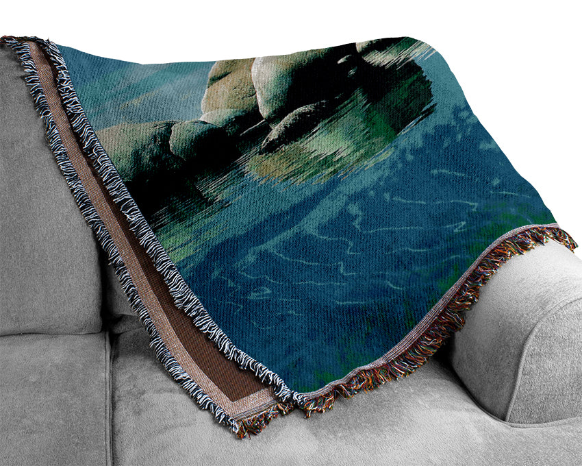 Aqua Rock Pool throw blanket made from 100% cotton, featuring a thermal weave design in a stylish color, draped elegantly over a couch.