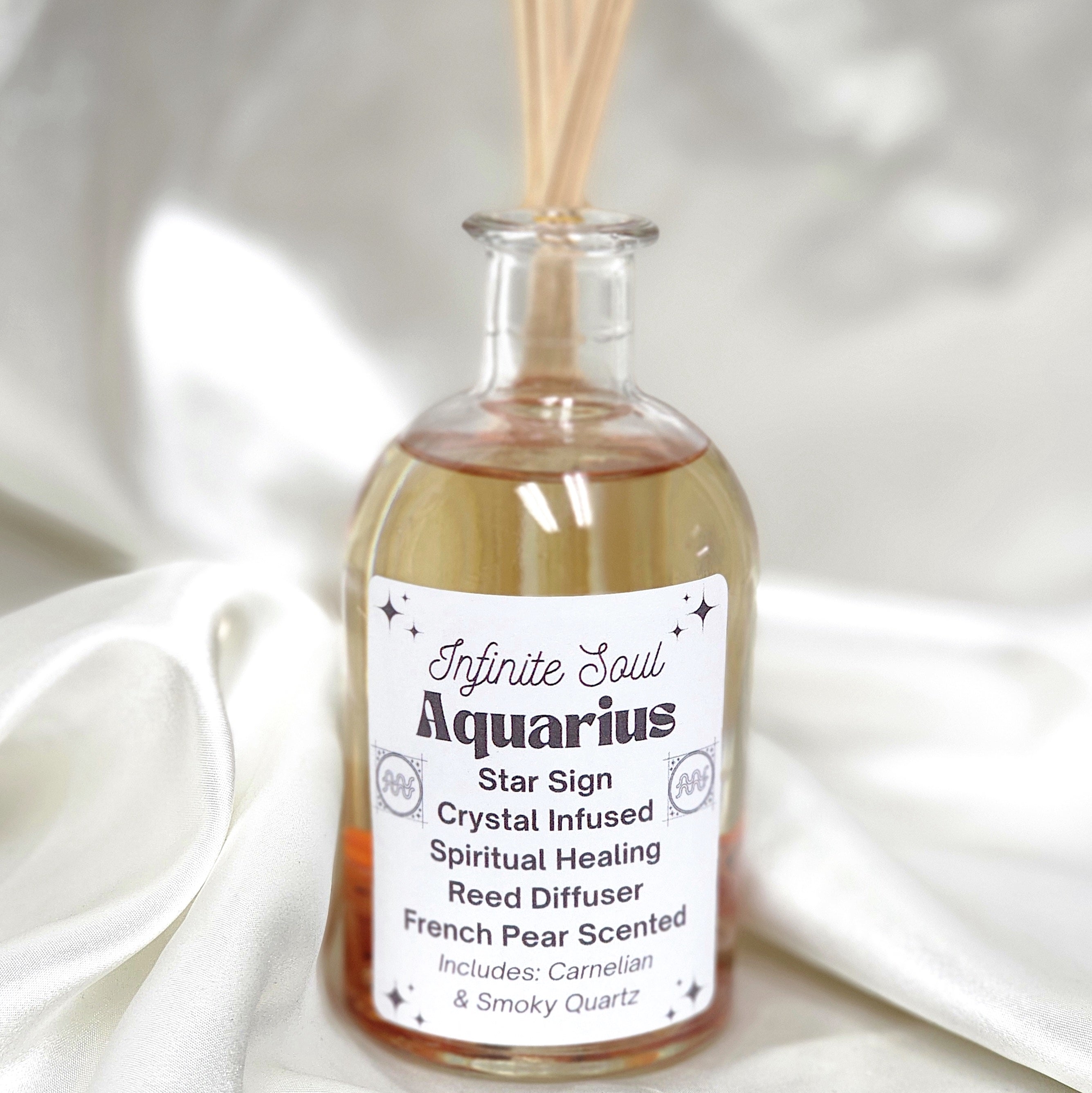 Aquarius Star Sign Crystal Infused Reed Diffuser with French Pear scent, featuring Carnelian and Smoky Quartz crystals.