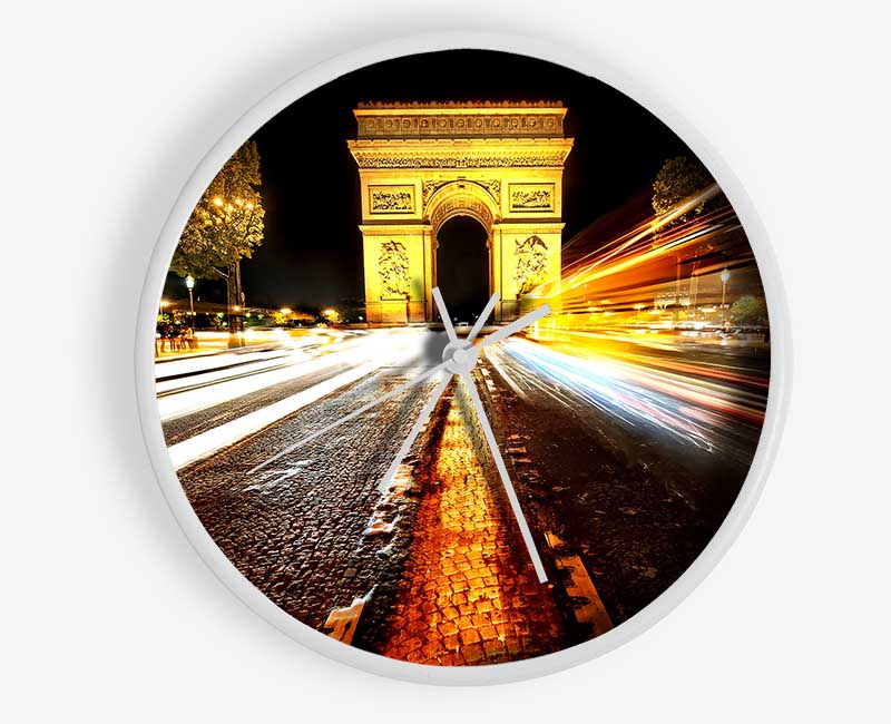 A stylish bamboo clock featuring the Arc De Triomphe illuminated at night, showcasing its round face and clear Plexiglas lens.