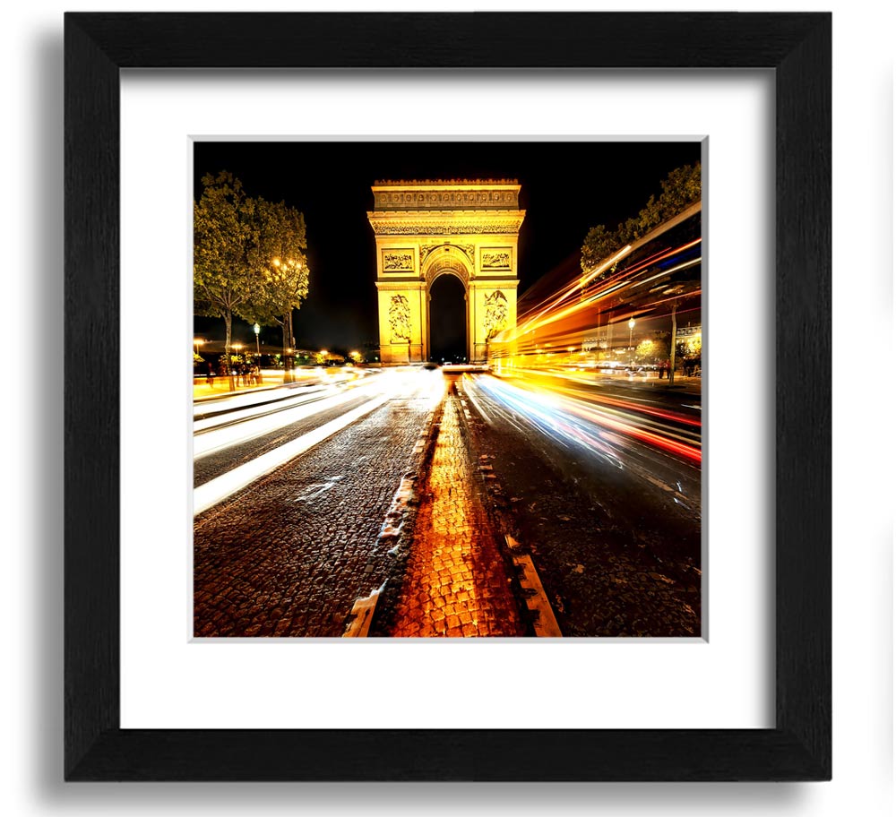 A beautifully framed print of the Arc De Triomphe illuminated at night, showcasing its architectural details and vibrant colors.