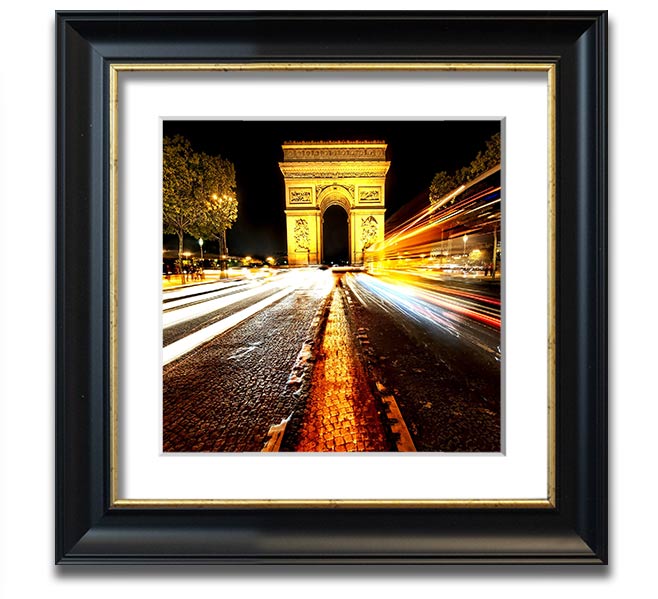 A beautifully framed print of the Arc De Triomphe illuminated at night, showcasing its architectural details and vibrant colors.