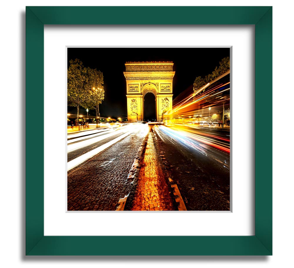 A beautifully framed print of the Arc De Triomphe illuminated at night, showcasing its architectural details and vibrant colors.