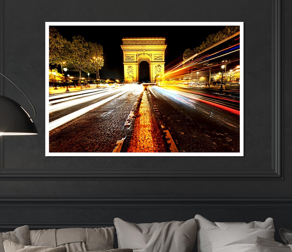 A beautifully illuminated Arc De Triomphe at night, showcasing its grandeur against a dark sky.