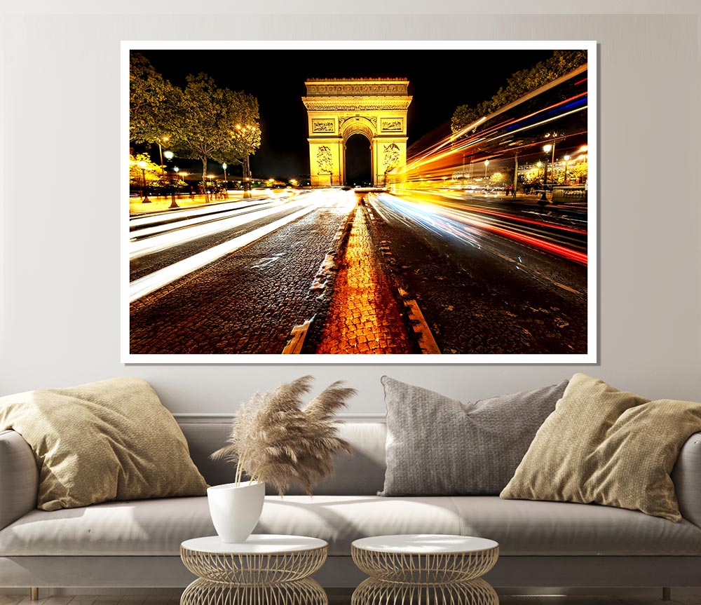 A beautifully illuminated Arc De Triomphe at night, showcasing its grandeur against a dark sky.