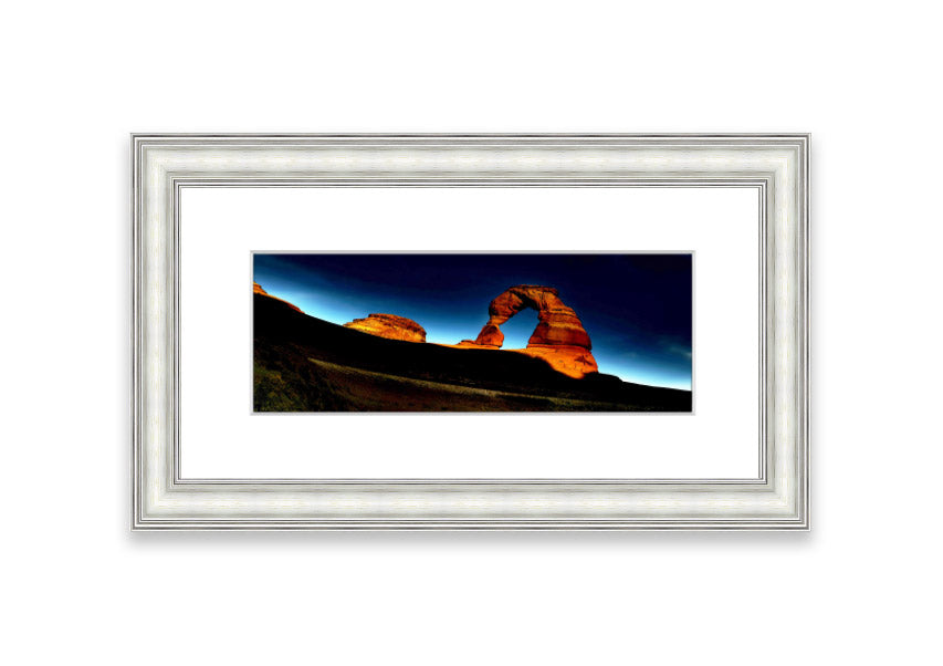 Framed print of Arch Rock Night, showcasing a stunning night sky over Cornwall's iconic rock formation.