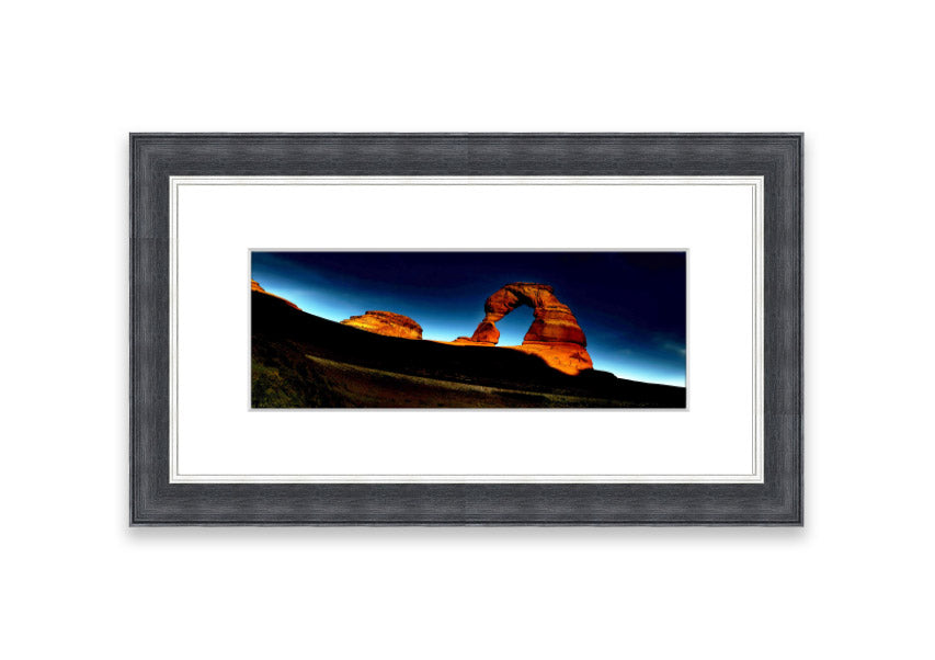 Framed print of Arch Rock Night, showcasing a stunning night sky over Cornwall's iconic rock formation.