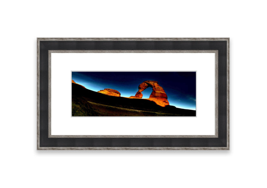 Framed print of Arch Rock Night, showcasing a stunning night sky over Cornwall's iconic rock formation.