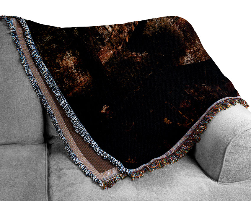 A luxurious Arched Bridge Reflections throw blanket made from 100% cotton, featuring a thermal weave design, elegantly draped over a couch.