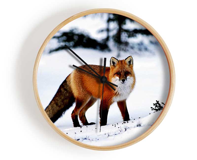 A stylish clock featuring an Arctic fox in a snowy landscape, crafted from natural bamboo with a clear Plexiglas lens.