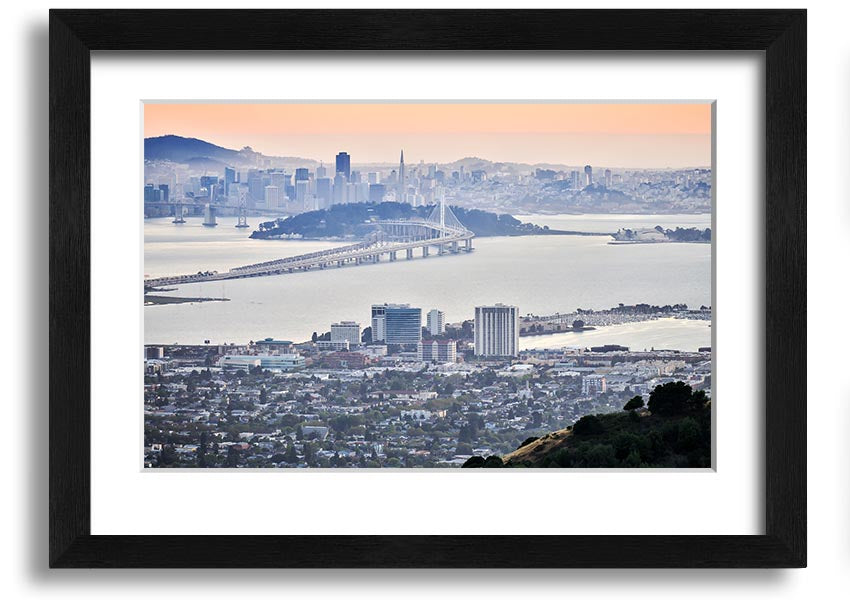 A framed print showcasing an aerial view of a vibrant city, available in various frame colors, ready to hang.