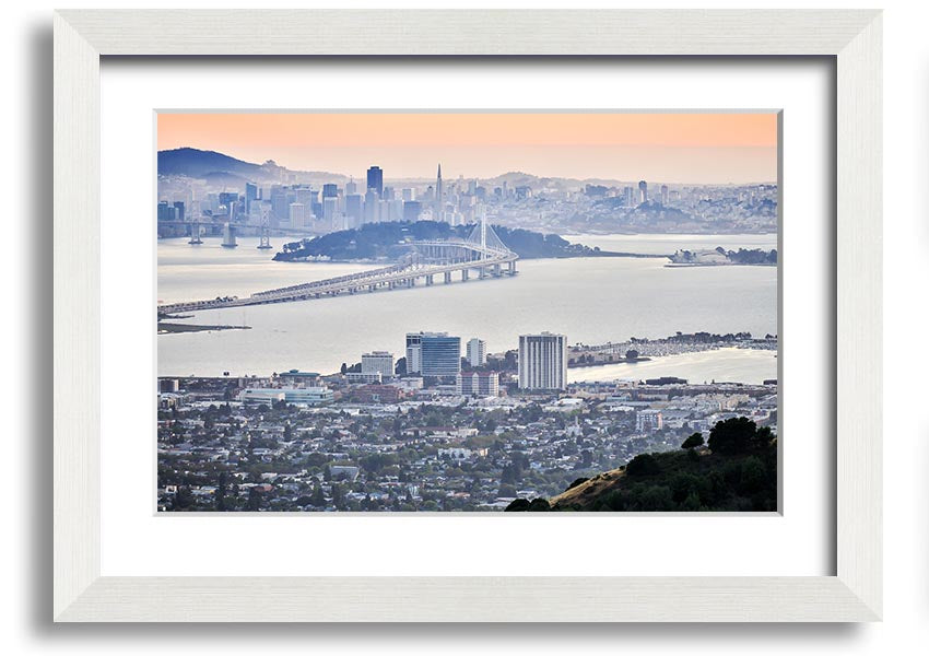 A framed print showcasing an aerial view of a vibrant city, available in various frame colors, ready to hang.