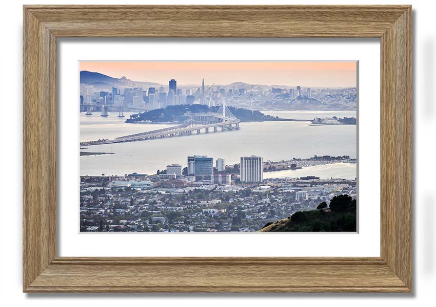 A framed print showcasing an aerial view of a vibrant city, available in various frame colors, ready to hang.