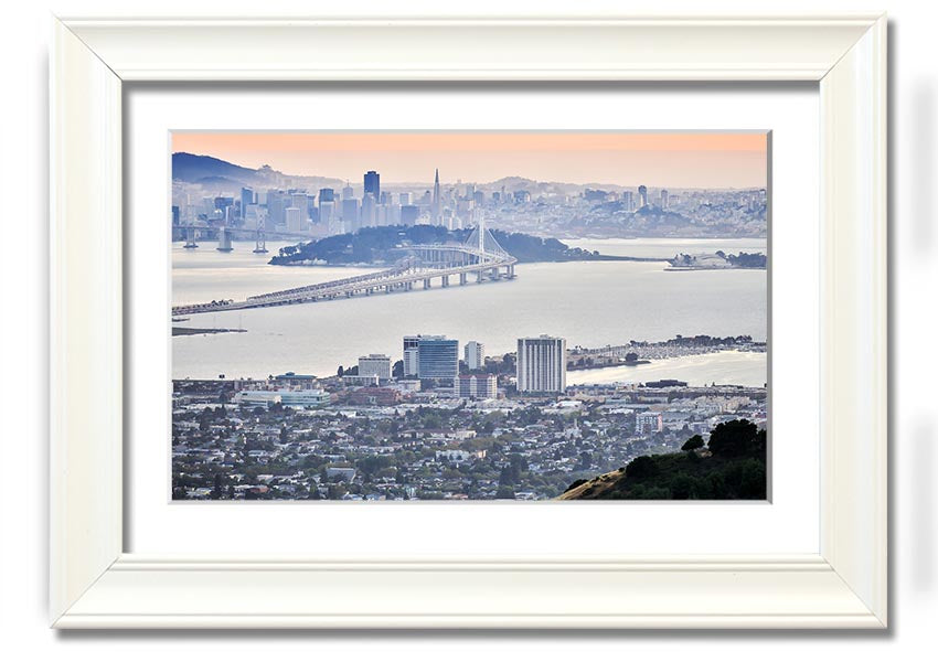 A framed print showcasing an aerial view of a vibrant city, available in various frame colors, ready to hang.