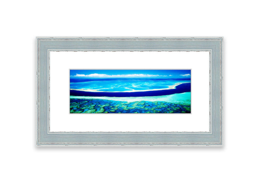 A framed print showcasing an aerial view of a turquoise ocean, beautifully capturing the vibrant colors and serene waves.