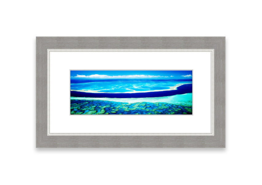 A framed print showcasing an aerial view of a turquoise ocean, beautifully capturing the vibrant colors and serene waves.