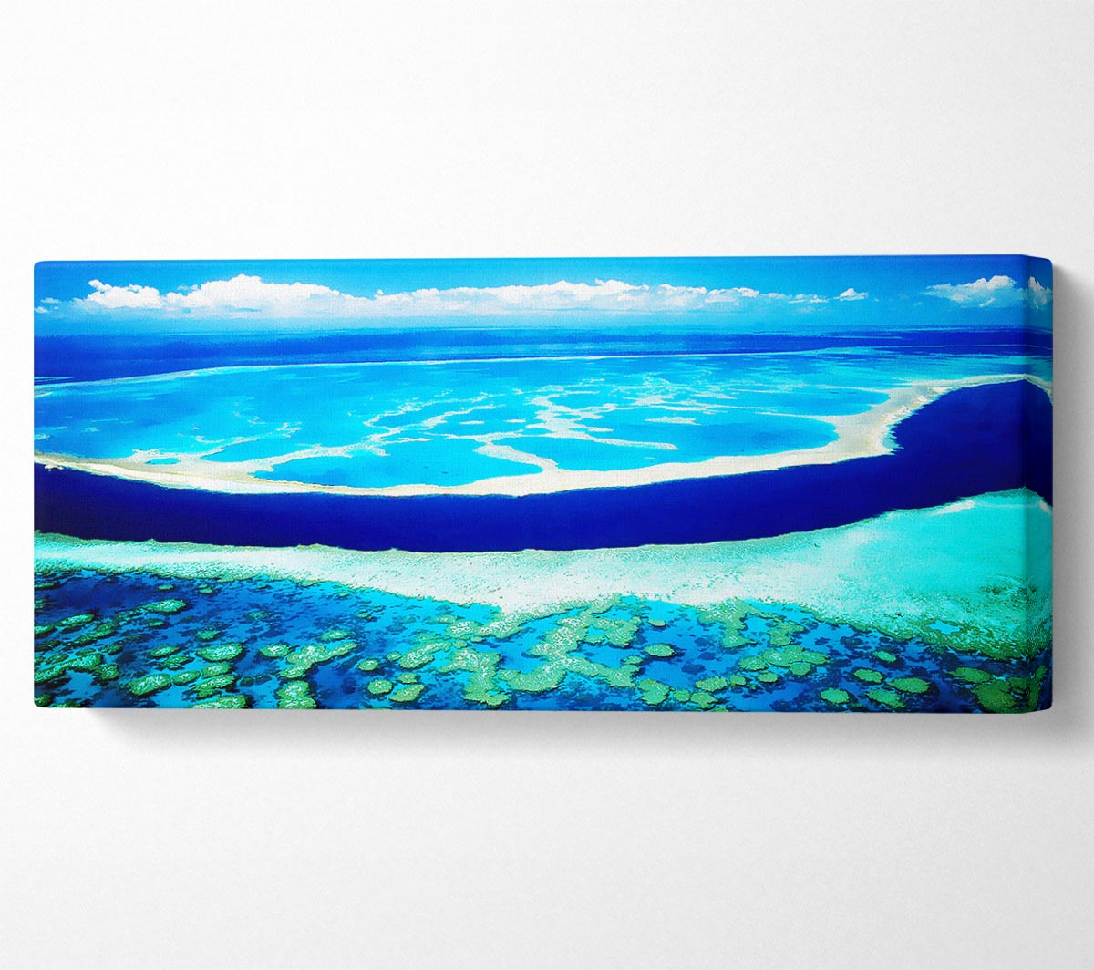 A beautiful canvas print of an aerial view of a turquoise ocean, mounted on a sturdy box frame, ready to hang.