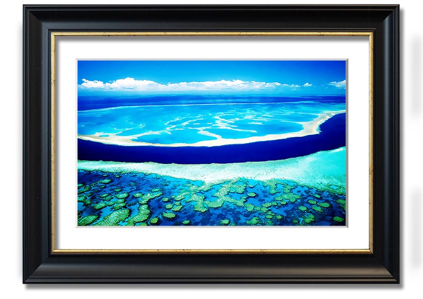 A framed print showcasing an aerial view of a turquoise ocean, highlighting vibrant blue waters and intricate patterns.