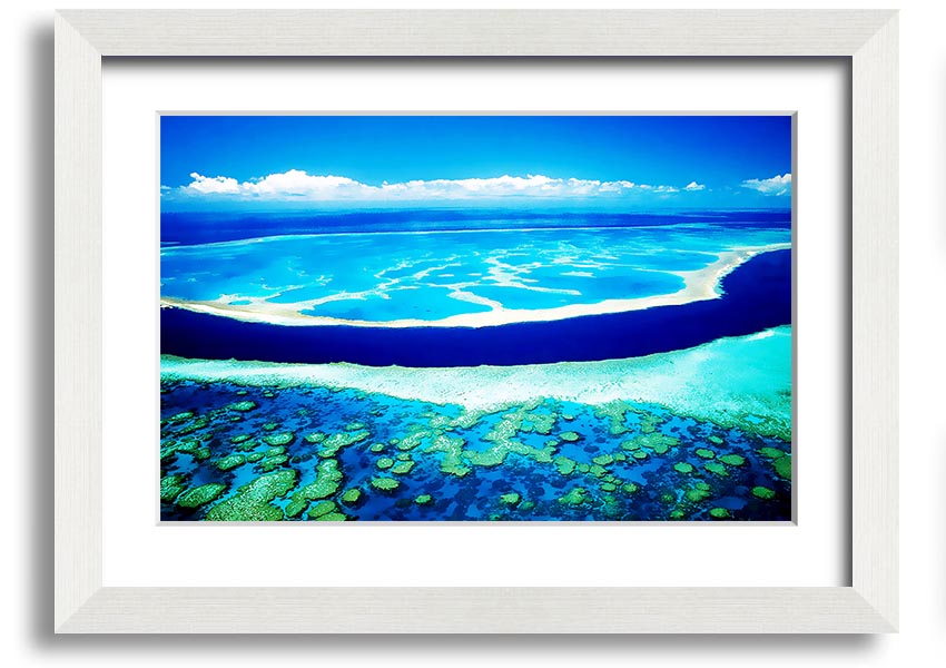 A framed print showcasing an aerial view of a turquoise ocean, highlighting vibrant blue waters and intricate patterns.