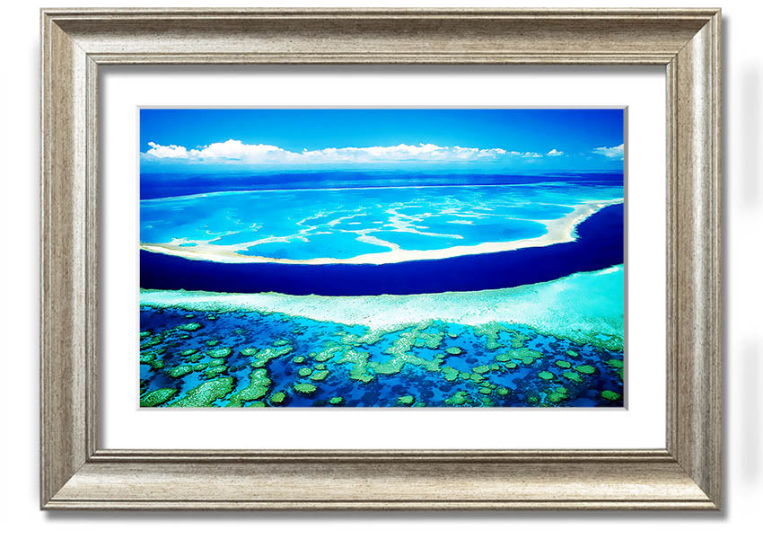 A framed print showcasing an aerial view of a turquoise ocean, highlighting vibrant blue waters and intricate patterns.