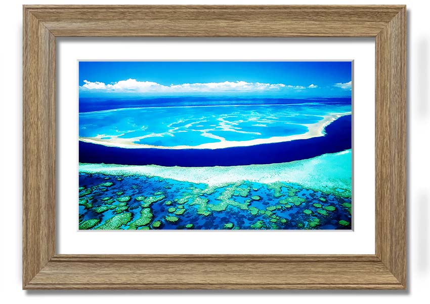 A framed print showcasing an aerial view of a turquoise ocean, highlighting vibrant blue waters and intricate patterns.