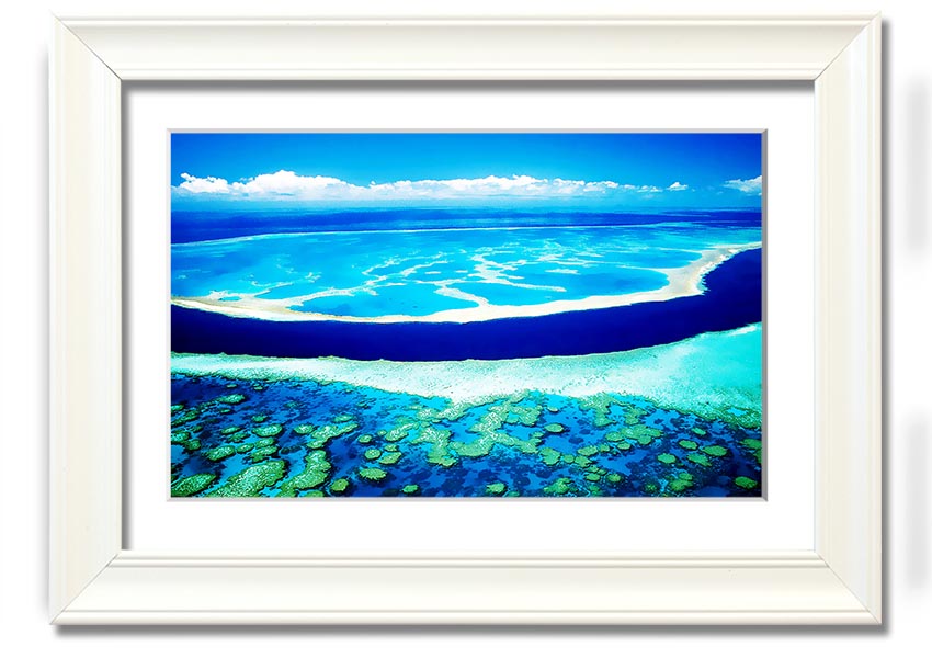 A framed print showcasing an aerial view of a turquoise ocean, highlighting vibrant blue waters and intricate patterns.