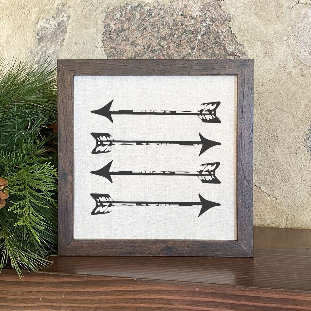 Stylized wood-framed sign featuring arrows on a linen-look background, perfect for home decor.