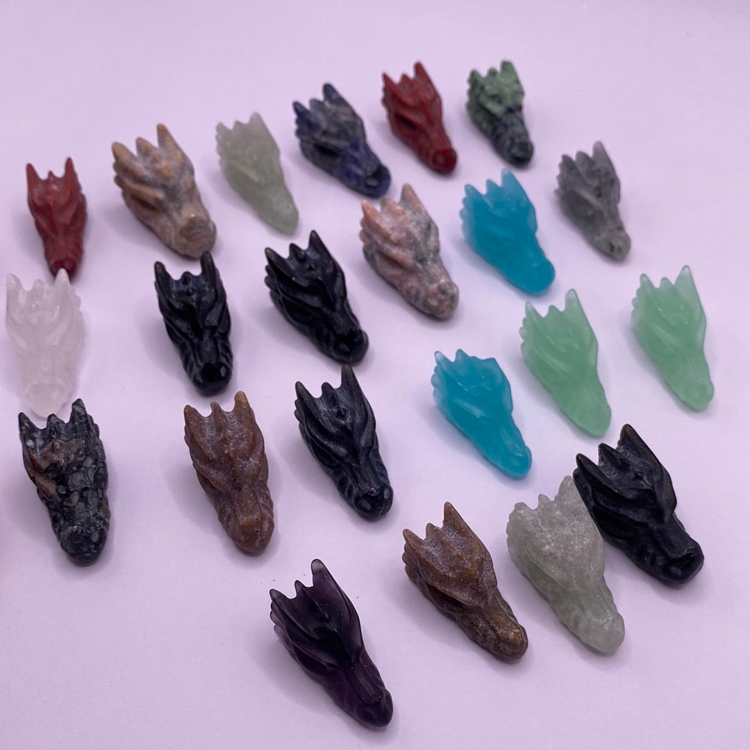 A colorful assortment of mini dragon heads, intricately designed with unique features and vibrant colors, radiating positive energy.