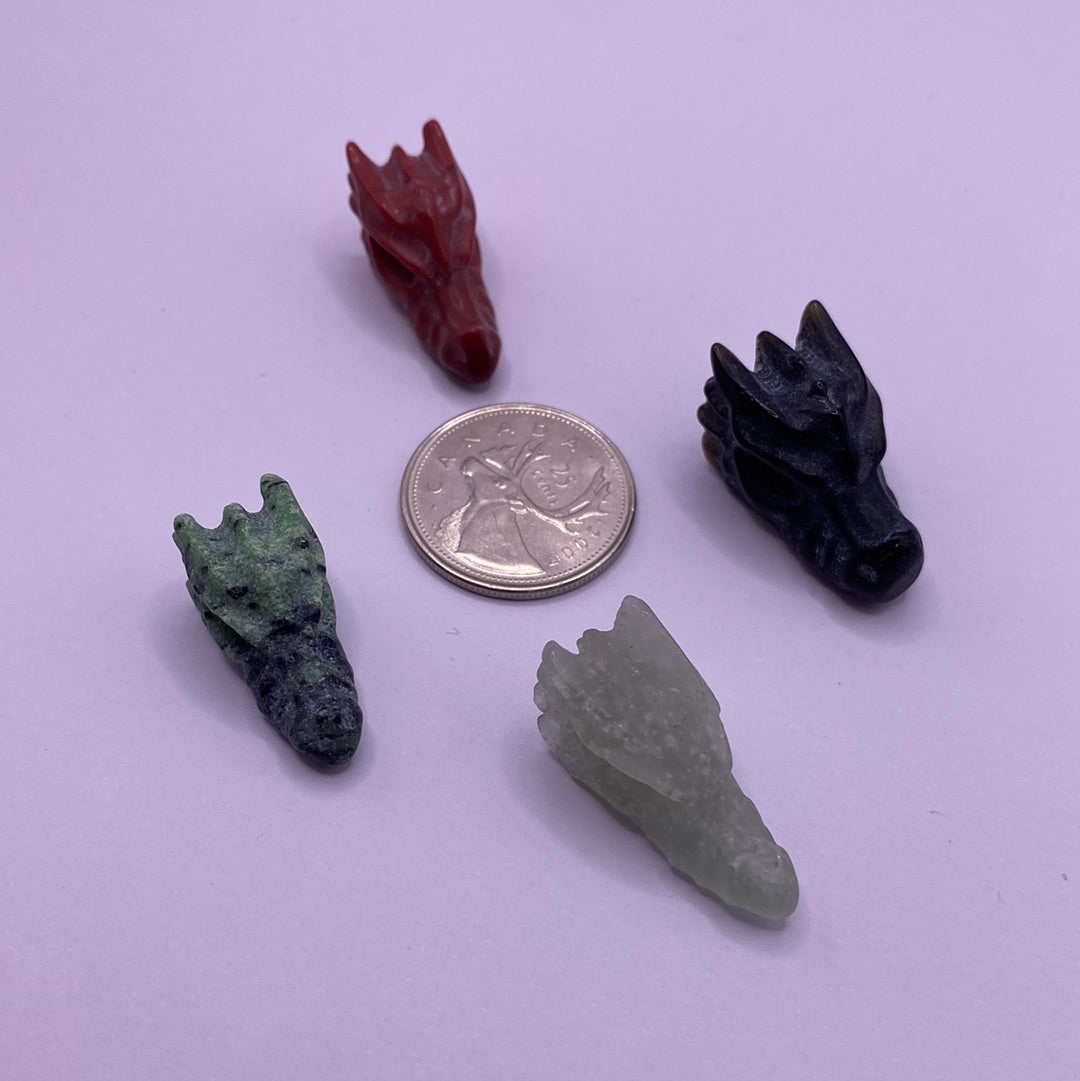 A colorful assortment of mini dragon heads, intricately designed with unique features and vibrant colors, radiating positive energy.