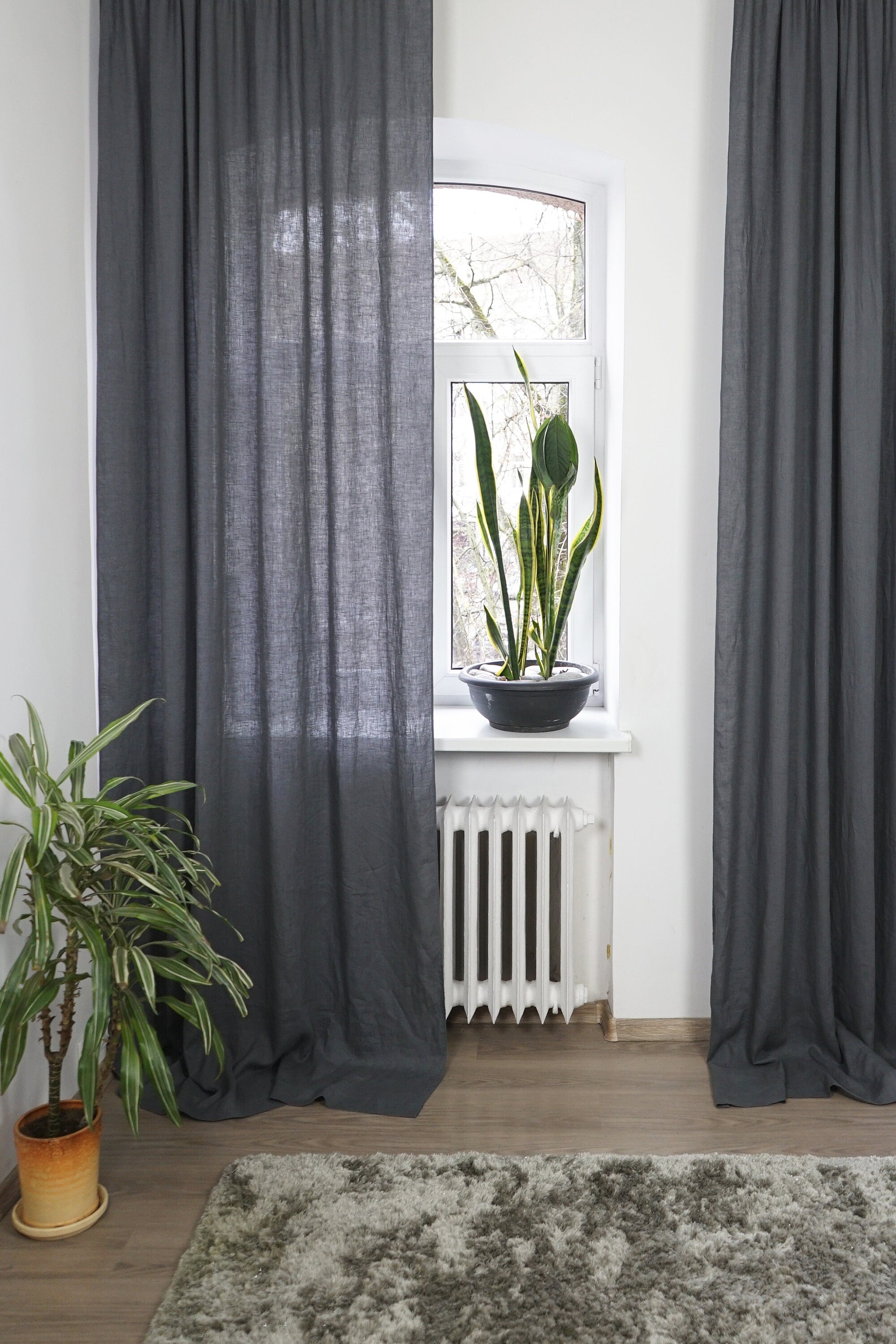 Asphalt Grey linen curtain with tab tops, elegantly draping and semi-sheer, showcasing its texture and color.