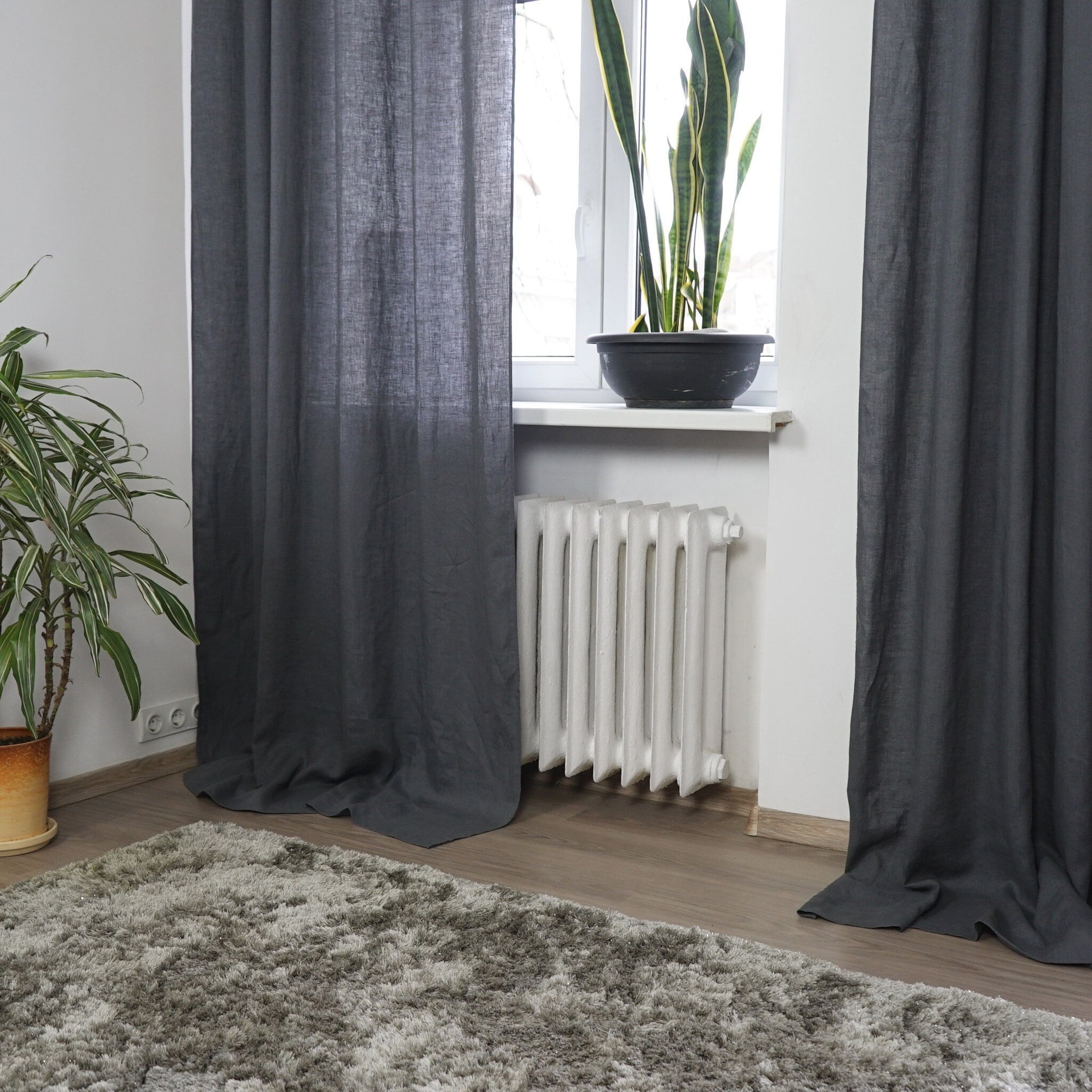 Asphalt Grey linen curtain with tab tops, elegantly draping and semi-sheer, showcasing its texture and color.