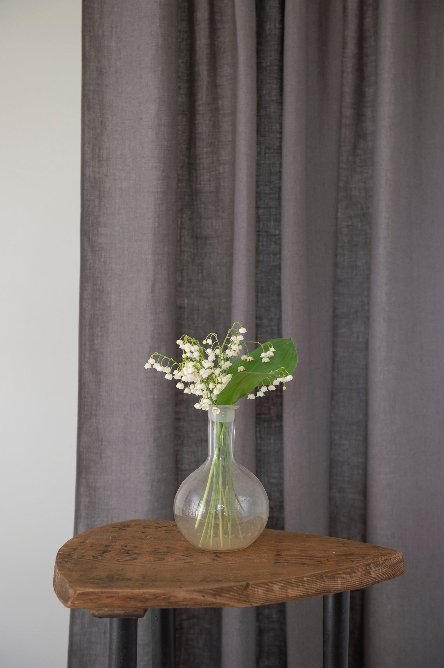 Asphalt Grey linen curtain with tab tops, elegantly draping and semi-sheer, showcasing its texture and color.