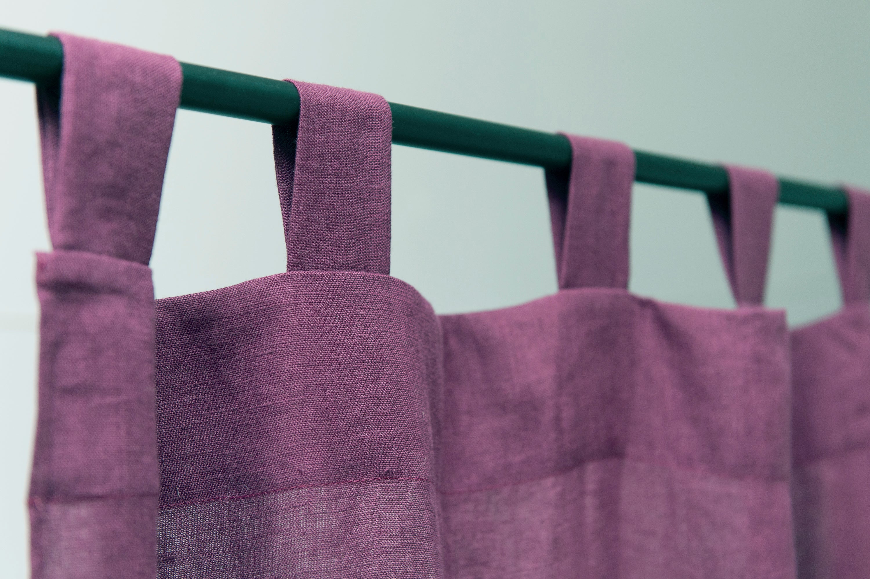 Asphalt Grey linen curtain with tab tops, elegantly draping and semi-sheer, showcasing its texture and color.