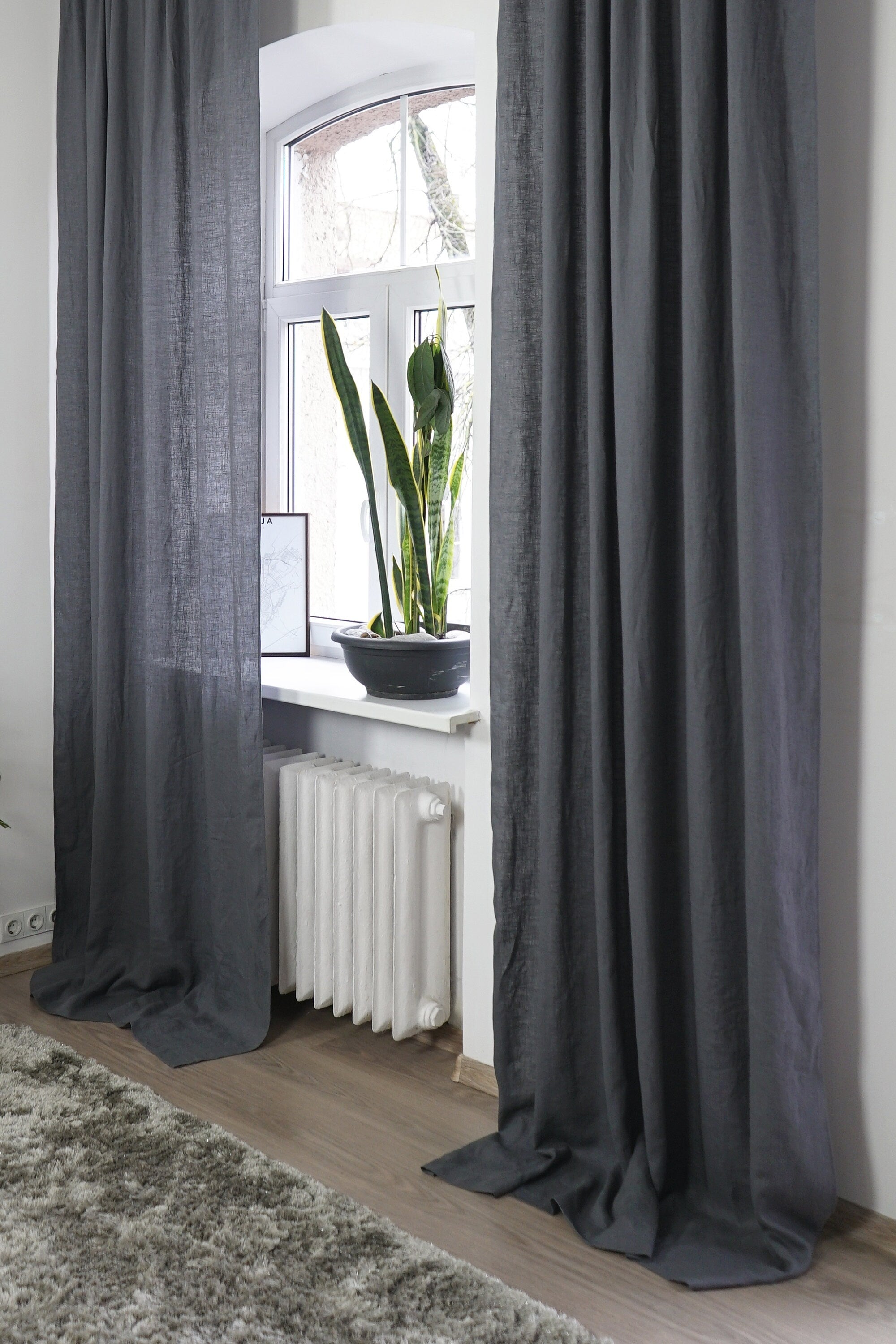 Asphalt Grey linen curtain with tab tops, elegantly draping and semi-sheer, showcasing its texture and color.