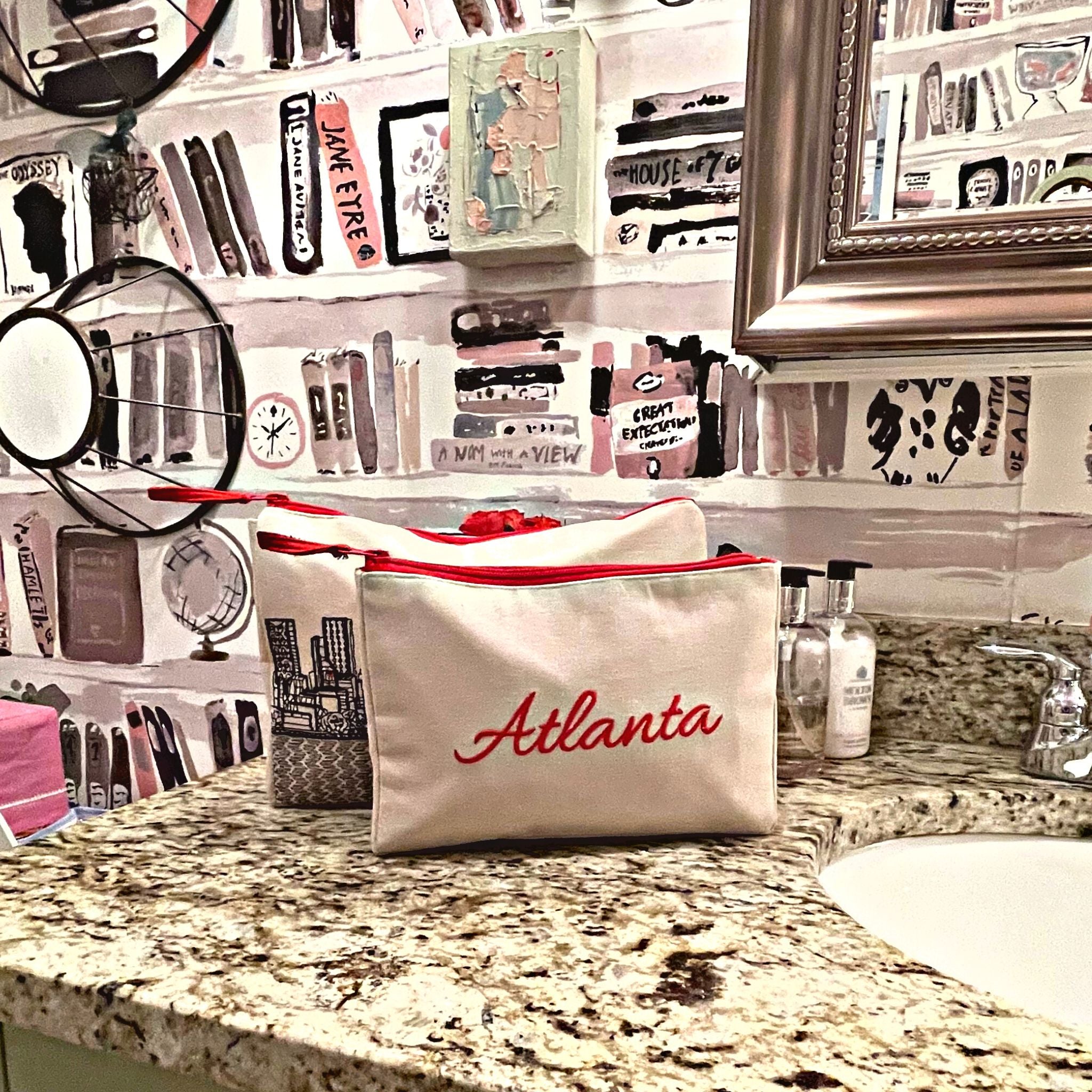 Atlanta Makeup Bag set featuring embroidered skyline design on cream and black cotton canvas with red waterproof lining.