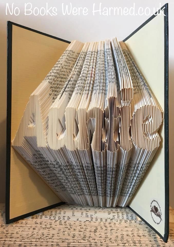 A unique hand-folded book art piece named 'Auntie', crafted from vintage books, showcasing intricate folds and textures.