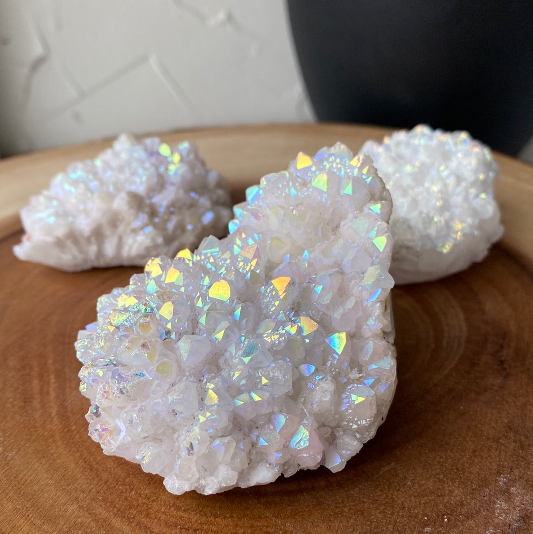 A vibrant Aura Quartz Cluster showcasing hues of pink, purple, blue, and gold, radiating healing energy.