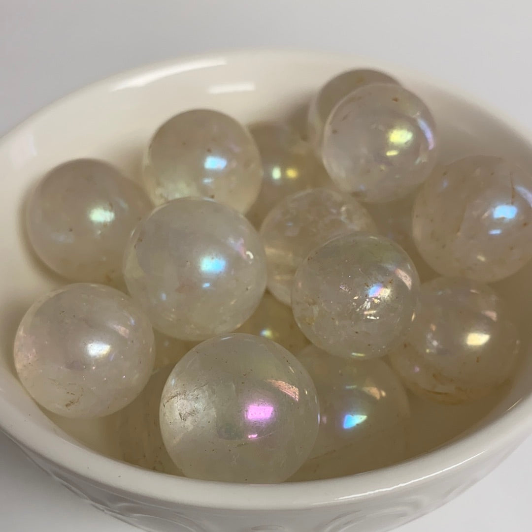 A vibrant Aura Quartz Mini Sphere approximately 1 inch in diameter, showcasing its iridescent colors and unique patterns.